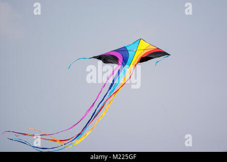 Rainbow colored kite with a long tail at International Kite Festival Stock Photo