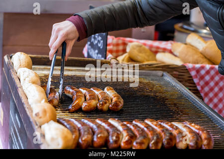 Cooking sausages on a market stall in Borough Market, London Stock Photo