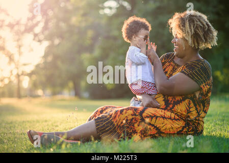 Mother and her baby daughter in a park Stock Photo