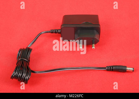 Electric shaver charger isolated on red background Stock Photo