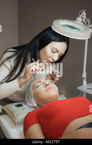 young woman working on eyelash extensions Stock Photo