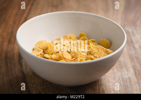 corn flakes in white bowl on table Stock Photo