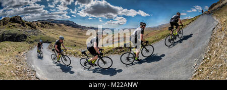 Cyclist  in a multiple image climbing Hardknott pass, cumbria. Stock Photo