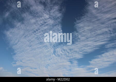 Clear, Blue Sky With Moving White Clouds On A Sunny Day. Stock Photo