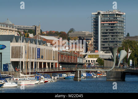 Bristol city centre showing the docks, harbourside, marina, lighthouse, cyclist, Bristol Cathedral behind and Pero's Bridge (grey horns) Stock Photo