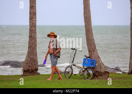 Man with his bicycle on the headland at Port Douglas in Rex Smeal Park,Port Douglas,Queensland,Australia Stock Photo