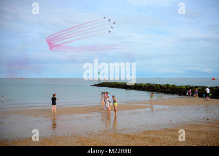 RAF Red Arrows at the Clacton on sea Airshow. People watching them flying over the sea Stock Photo