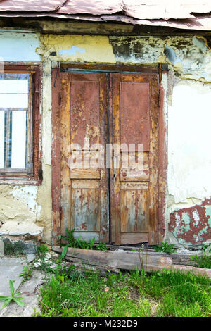 old wooden door with cracked brown paint Stock Photo
