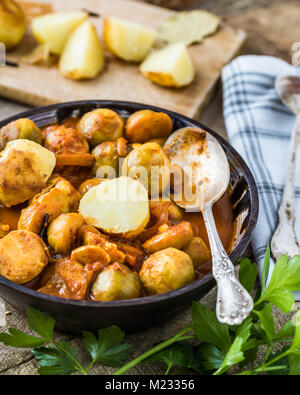 Roasted brussel sprouts with potatoes in homemade ceramic bowl. Stock Photo