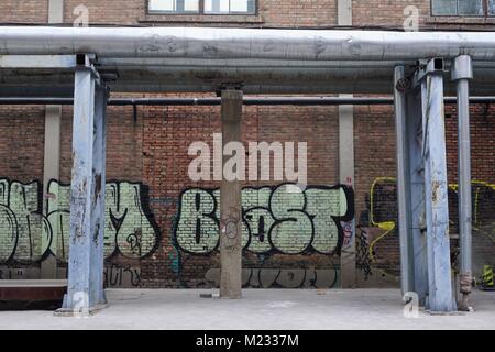 Industrial area with pipes and graffiti in Beijing China Stock Photo