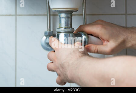 Plumber repairing very old pipeline in the house. Stock Photo