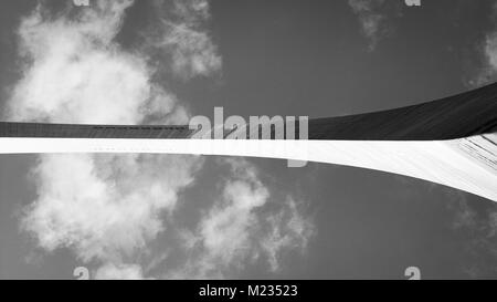 St. Louis, Mo USA- October 5 2016: St. Louis Arch from underneath in black and white showing viewing windows. Arch splits the frame intersecting cloud Stock Photo