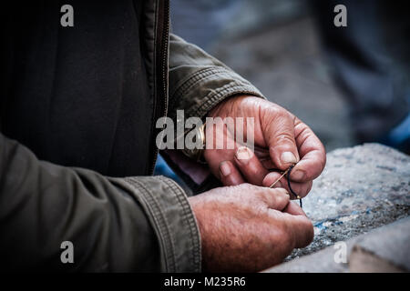 Working on things old man on market Stock Photo