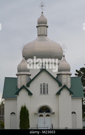 A wonderful little Ukrainian Orthodox church, sits in a Saskatchewan field waiting for next Sunday for the congregation to return Stock Photo