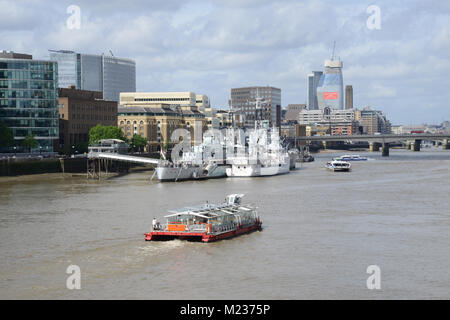 Thames river cruise passing HMS Belfast in London UK Stock Photo