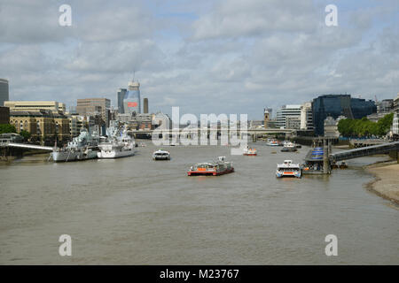 Thames river cruise passing HMS Belfast in London UK Stock Photo