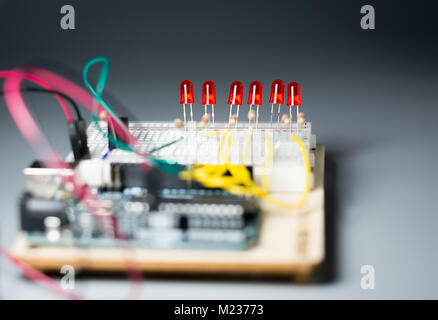 Array of red LEDs on a breadbord connected to a microcontroller Stock Photo