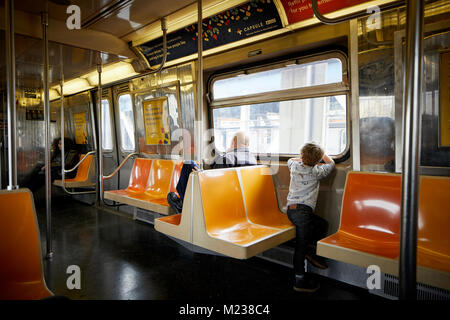 New York city in Manhattan, young boy looking out of the window of a subway train Stock Photo