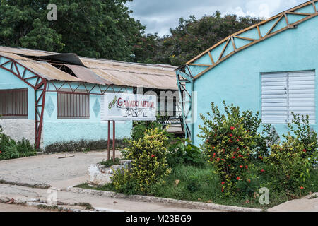 Las Tunas, Cuba - September 4, 2017: The panels of a metal roof for a building used for small livestock begin to fall off at the city fairgrounds. Stock Photo