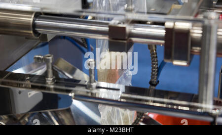 rice pack in plastic bag by packing machine Stock Photo