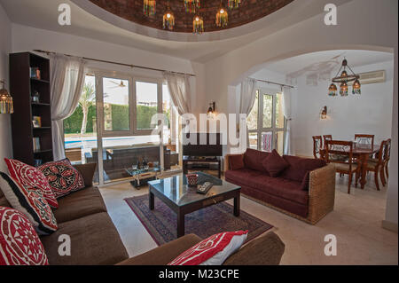 Living room lounge area in luxury villa show home showing interior design decor furnishing and garden view Stock Photo