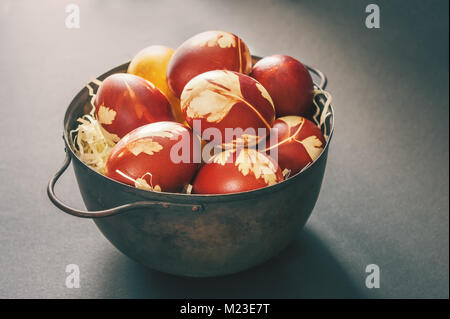 Painted colorful Easter eggs in a metal big bowl. Copy space. A horizontal frame. Stock Photo