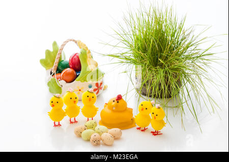 Yellow Easter Chicks and basket ceramic Easter eggs on a light background. Copy space. Stock Photo