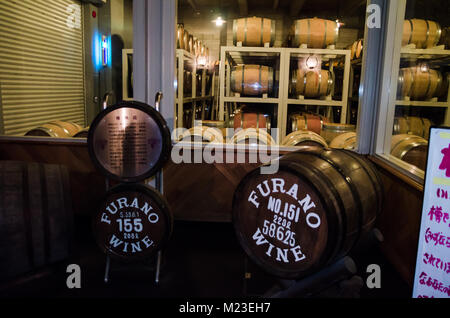 Wooden barrels use to store Japanese wine produced in wineries on Furano, Hokkaido. Furano Winery is open to the public and includes free wine tasting Stock Photo