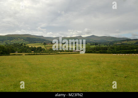 The Brecon Beacons ridge from fields near the A40 East of Brecon with Fan y Big above Cwm Oergwm and, to the right, Cribyn rising above Cwm Sere and o Stock Photo