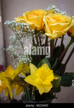 Still life with bouquet of yellow daffodils and candlestick Stock Photo ...