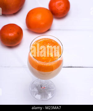 Panna cota with tangerines in a glass beaker, top view Stock Photo