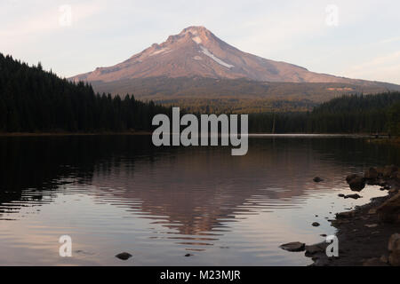 Some snow still remains on the high elevation of Mt Hood seen here from Trillium Lake Stock Photo