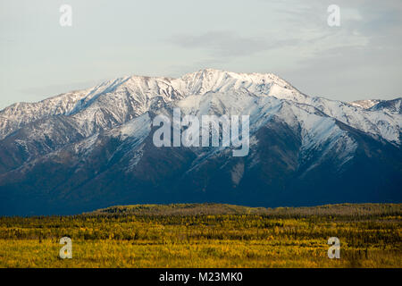 Snow capped mountain deep dark ridge winter landscape Alaska outback North America