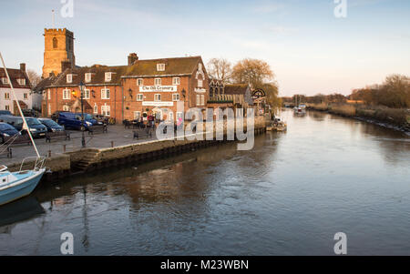 Wareham, England - March 25, 2016: The church and Old Grannary Pub on the River Frome at Wareham Quay in Dorset. Stock Photo