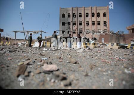 Sanaa, Yemen. 04th Feb, 2018. Yemeni men inspect the damage caused by an alleged Saudi-led air strike against a Houthi rebels-held criminal research building in Sanaa, Yemen, 04 February 2018. Credit: Hani Al-Ansi/dpa/Alamy Live News Stock Photo