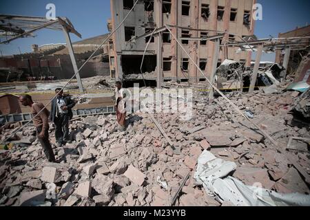 Sanaa, Yemen. 04th Feb, 2018. Yemeni men inspect the damage caused by an alleged Saudi-led air strike against a Houthi rebels-held criminal research building in Sanaa, Yemen, 04 February 2018. Credit: Hani Al-Ansi/dpa/Alamy Live News Stock Photo