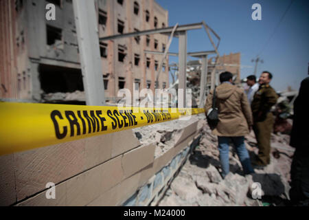 Sanaa, Yemen. 04th Feb, 2018. Yemeni men inspect the damage caused by an alleged Saudi-led air strike against a Houthi rebels-held criminal research building in Sanaa, Yemen, 04 February 2018. Credit: Hani Al-Ansi/dpa/Alamy Live News Stock Photo