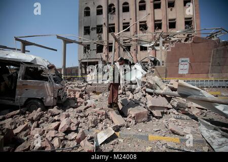 Sanaa, Yemen. 04th Feb, 2018. A Yemeni man inspects the damage caused by an alleged Saudi-led air strike against a Houthi rebels-held criminal research building in Sanaa, Yemen, 04 February 2018. Credit: Hani Al-Ansi/dpa/Alamy Live News Stock Photo