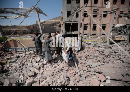 Sanaa, Yemen. 04th Feb, 2018. Yemeni men inspect the damage caused by an alleged Saudi-led air strike against a Houthi rebels-held criminal research building in Sanaa, Yemen, 04 February 2018. Credit: Hani Al-Ansi/dpa/Alamy Live News Stock Photo