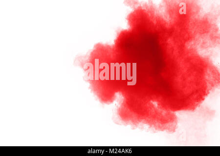 abstract red dust splattered on  white background. Red powder explosion on white background. Freeze motion of red particles splash. Stock Photo