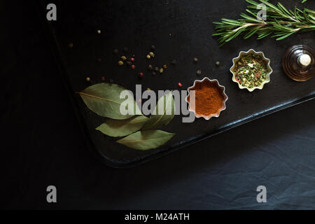 Food spices and seasonings on a black pan Stock Photo