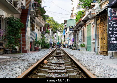HANOI, VIETNAM - MAY 23, 2017: Hanoi train street with railroad passing through the neighborhood representing bad living conditions. Vietnam travel Stock Photo