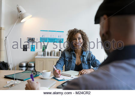 Smiling small business owners working, planning at table