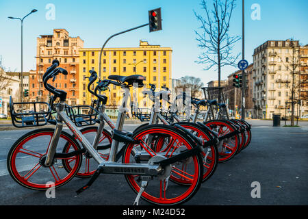 'Free floating' Chinese Mobike sharing bike-scheme in Milan, Italy. Locals can pick up and ride a bike around the city at any time by downloading the app Stock Photo