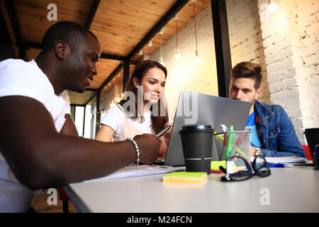 Startup Diversity Teamwork Brainstorming Meeting Concept.Business Team Coworkers Sharing World Economy Report Document Laptop.People Working Planning Start Up.Group Young Hipsters Discussing Cafe Stock Photo