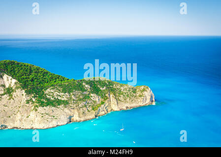 Exotic place for summer travelling. Summer vacation background. Lonely boat at azure sea near island Stock Photo