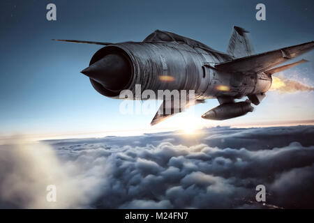 Fighter jet above the clouds Stock Photo