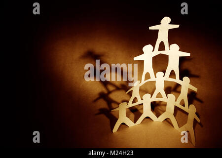 Human team pyramid supporting each other Stock Photo - Alamy