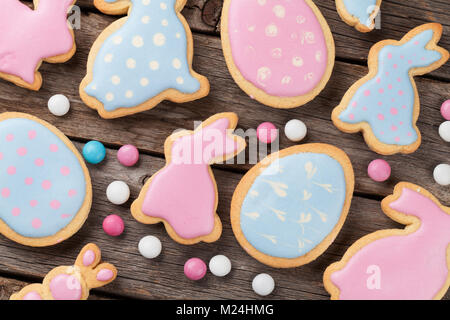 Easter gingerbread cookies on wooden table. Colorful rabbits and eggs. Top view Stock Photo