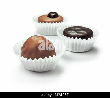 Delicious chocolate candy or chocolate truffle with paper, isolated on white background. Stock Photo